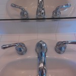 Removed cracked grout and caulked joint